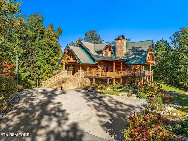 back of property featuring covered porch