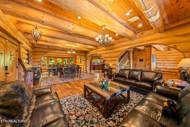 living room featuring beamed ceiling, wood-type flooring, wood ceiling, a chandelier, and log walls