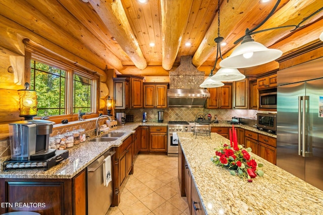 kitchen featuring decorative light fixtures, beam ceiling, light stone countertops, sink, and high end appliances