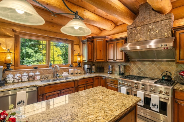 kitchen featuring sink, appliances with stainless steel finishes, tasteful backsplash, wall chimney exhaust hood, and decorative light fixtures