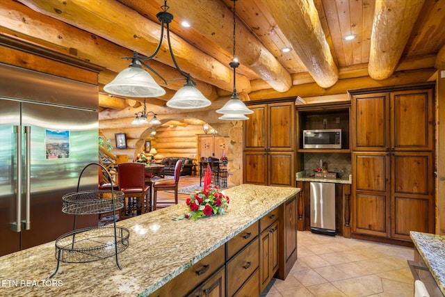 kitchen with stainless steel appliances, light tile patterned flooring, beam ceiling, light stone countertops, and decorative light fixtures