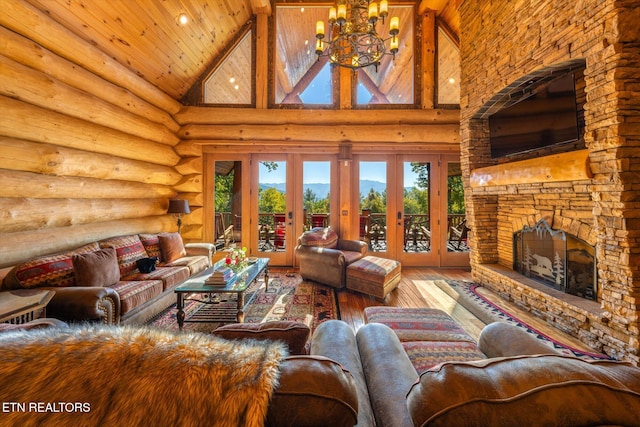 living room featuring french doors, a fireplace, hardwood / wood-style floors, and high vaulted ceiling