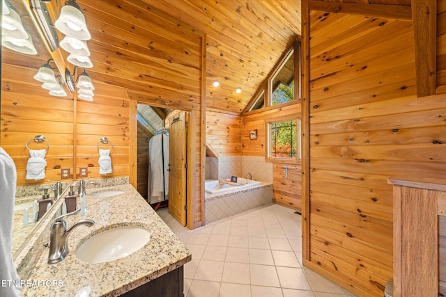 bathroom featuring wood walls, tile patterned flooring, vanity, a washtub, and vaulted ceiling