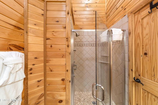 bathroom with walk in shower and wooden walls