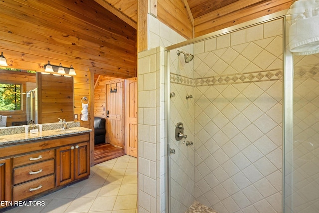 bathroom with lofted ceiling, tile patterned flooring, wood walls, vanity, and walk in shower