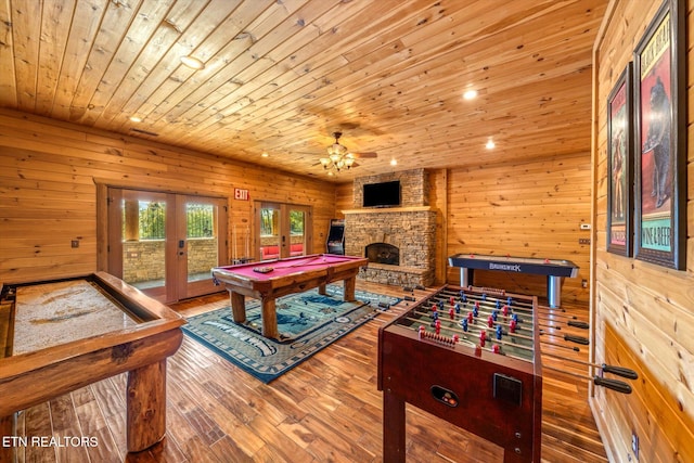 recreation room with wooden walls, french doors, wooden ceiling, and wood-type flooring