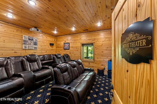 cinema featuring wood walls, wooden ceiling, and carpet