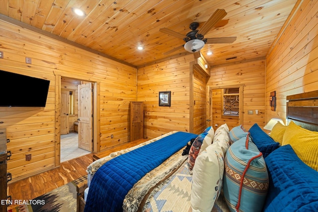 bedroom featuring light wood-type flooring, wooden walls, ceiling fan, and wooden ceiling