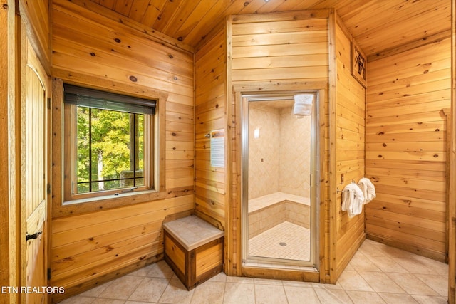 bathroom with wooden walls, wood ceiling, and tile patterned flooring