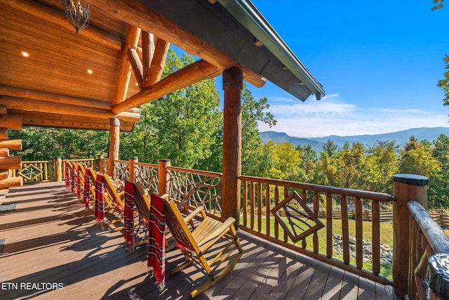 wooden deck featuring a mountain view