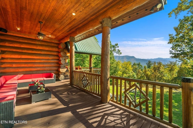 deck with a mountain view and outdoor lounge area