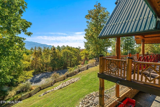 view of yard with a deck with mountain view