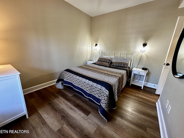 bedroom featuring wood finished floors and baseboards