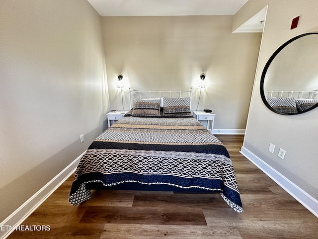 bedroom featuring baseboards and wood finished floors