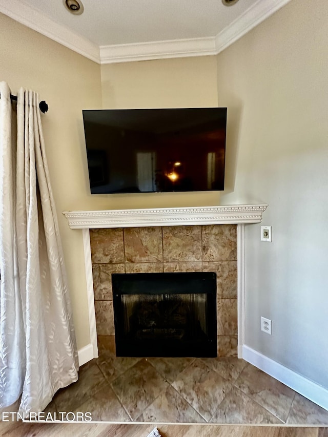 details with crown molding, baseboards, and a fireplace