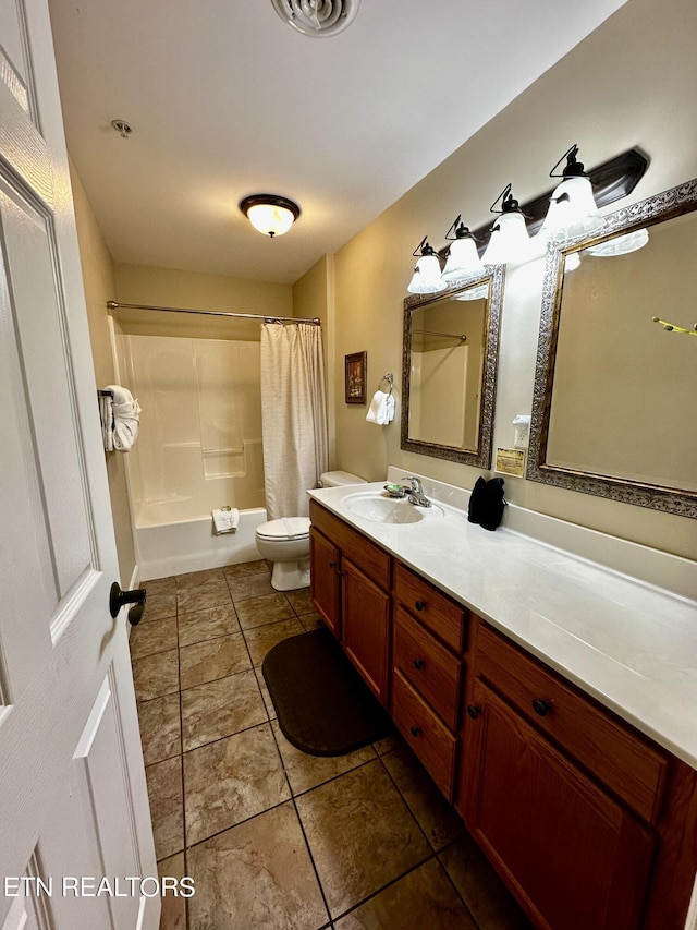 full bath with shower / bath combo with shower curtain, vanity, toilet, and tile patterned flooring