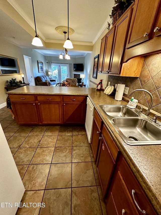 kitchen featuring decorative backsplash, white dishwasher, a sink, open floor plan, and crown molding