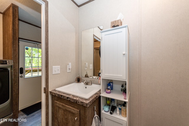 bathroom featuring washer / clothes dryer, hardwood / wood-style flooring, and vanity