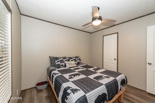 bedroom with dark wood-type flooring, ornamental molding, a textured ceiling, and ceiling fan