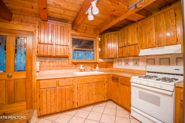 kitchen with beamed ceiling, white range with gas stovetop, wood ceiling, sink, and light tile patterned floors