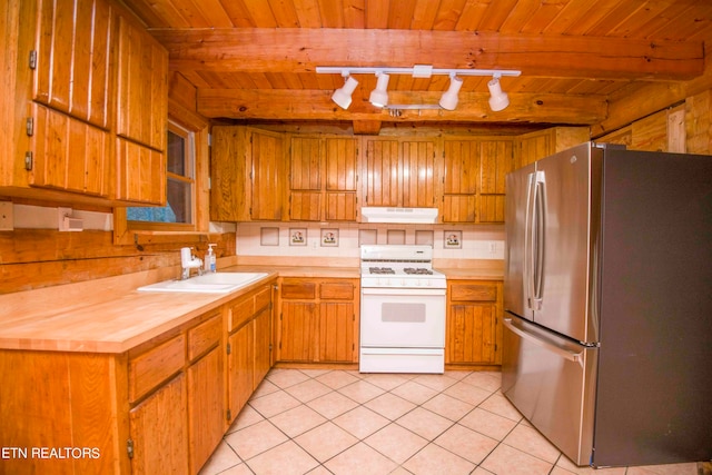 kitchen featuring wood ceiling, stainless steel fridge, white gas stove, and sink