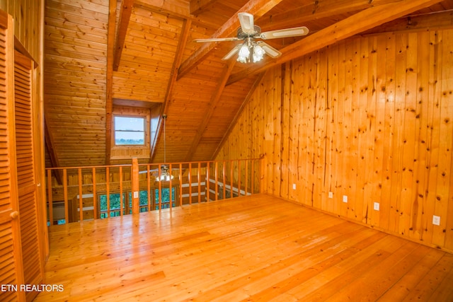 additional living space with wood-type flooring, wooden ceiling, vaulted ceiling with beams, and ceiling fan