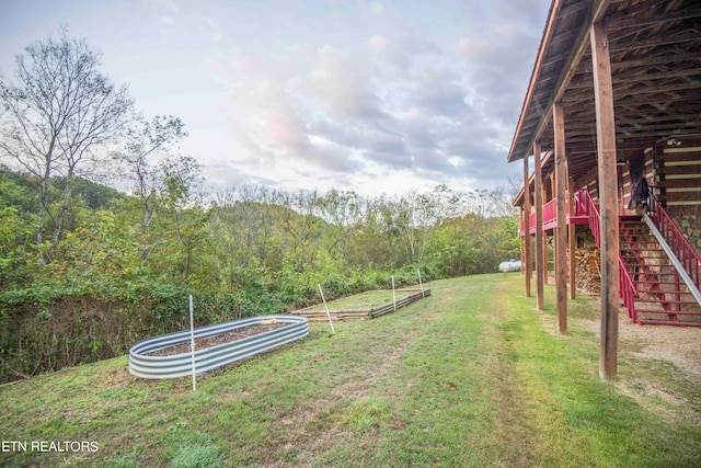 view of yard with a trampoline and a wooden deck