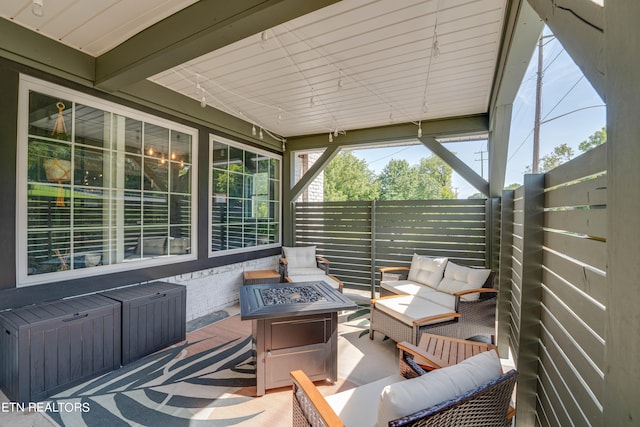 view of patio featuring an outdoor living space with a fire pit