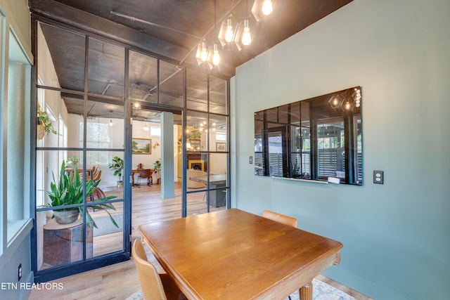 dining space with light wood-type flooring and a chandelier