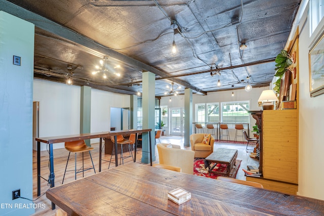 dining area featuring hardwood / wood-style flooring and beam ceiling