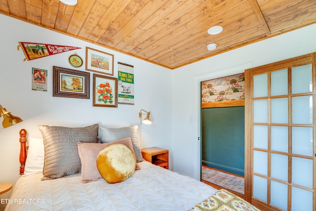 bedroom with wood-type flooring, ornamental molding, vaulted ceiling, and wooden ceiling