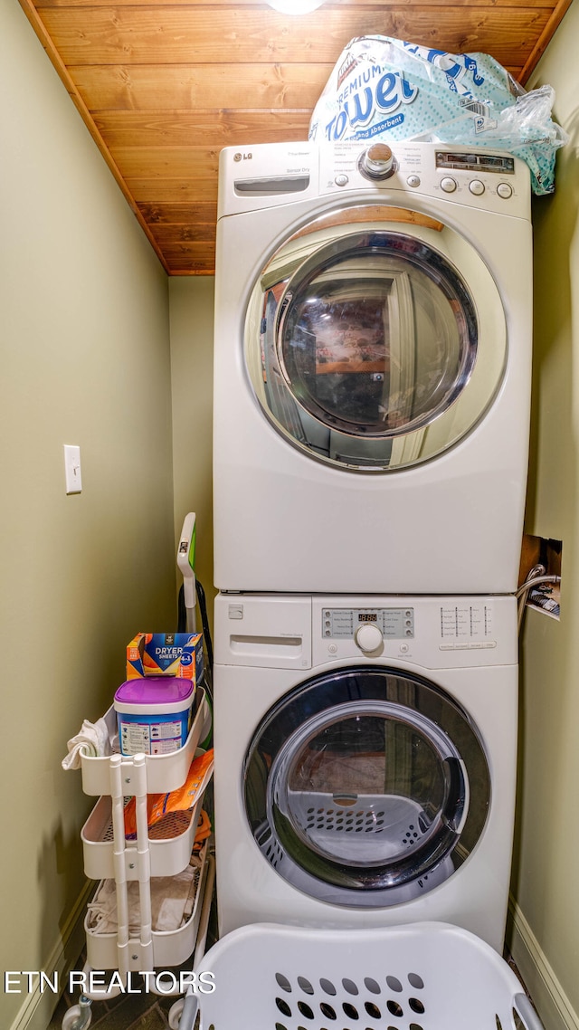 washroom featuring wooden ceiling and stacked washer and dryer