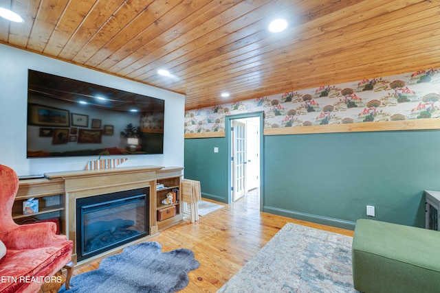 living room featuring light hardwood / wood-style flooring and wooden ceiling