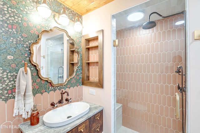 bathroom with vanity and tiled shower