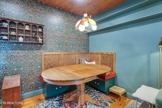 dining room featuring hardwood / wood-style floors and wooden ceiling