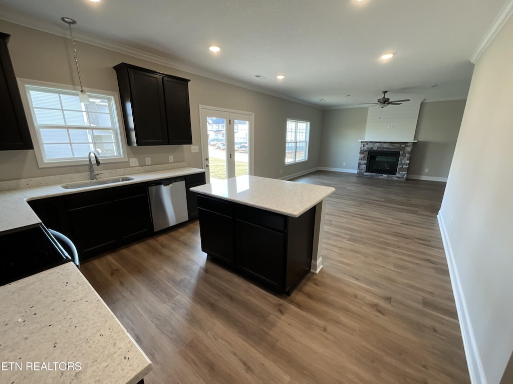 kitchen featuring sink, dishwasher, a center island, dark hardwood / wood-style flooring, and decorative light fixtures