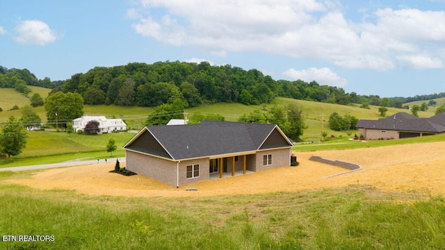 back of house with a rural view