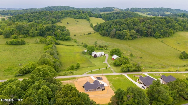 birds eye view of property with a rural view