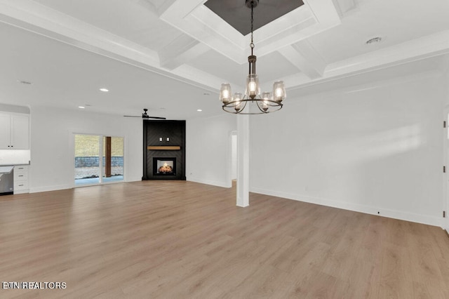 unfurnished living room with light hardwood / wood-style flooring, beam ceiling, and a fireplace