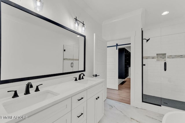 bathroom featuring vanity, ornamental molding, wood-type flooring, and an enclosed shower