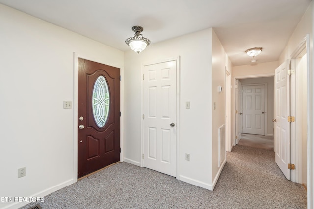 view of carpeted foyer entrance