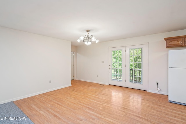 interior space with a chandelier and light hardwood / wood-style flooring