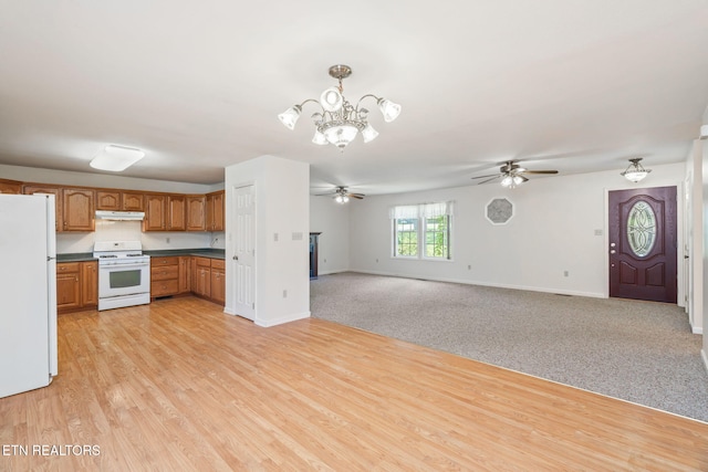 kitchen featuring ceiling fan with notable chandelier, white appliances, light hardwood / wood-style floors, and decorative light fixtures