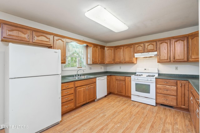 kitchen with light hardwood / wood-style flooring, sink, and white appliances