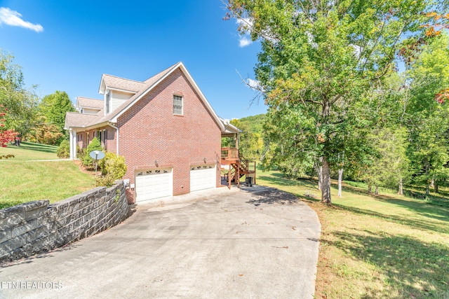 view of side of property with a yard and a garage