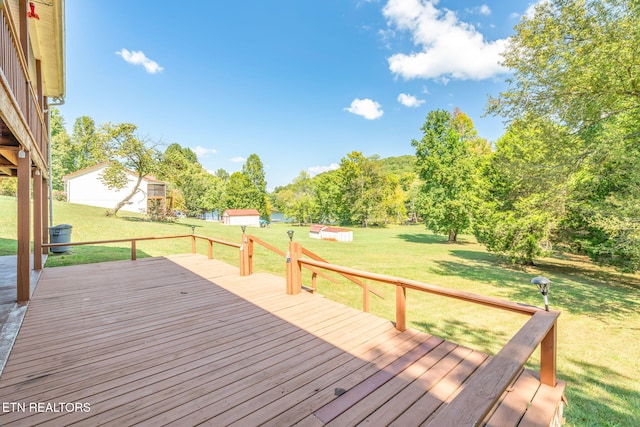 deck with a shed and a yard