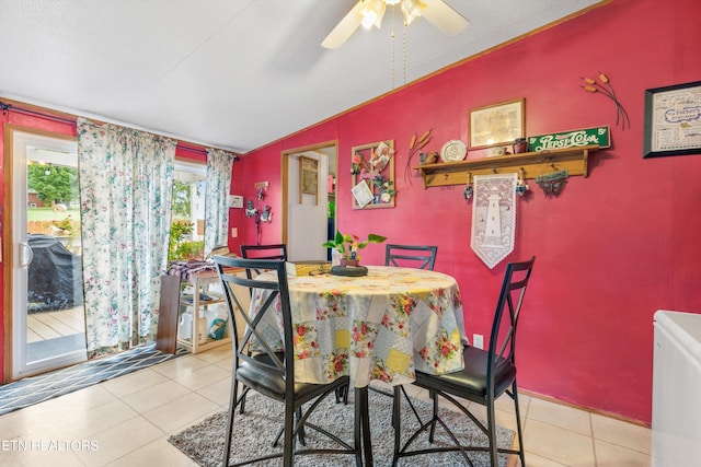 tiled dining area with lofted ceiling and ceiling fan