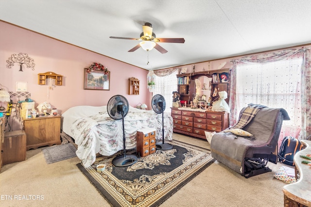 bedroom with ceiling fan, light colored carpet, and a textured ceiling