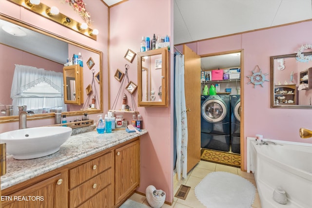 bathroom featuring tile patterned flooring, vanity, washer and dryer, and a shower with curtain