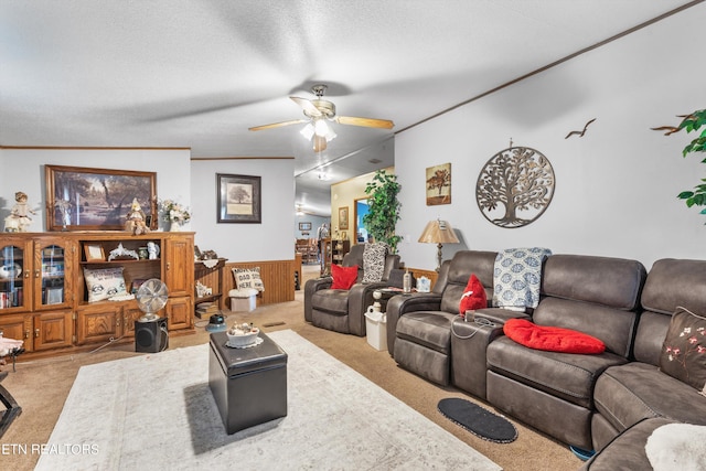 living room with vaulted ceiling, wood walls, a textured ceiling, ceiling fan, and light colored carpet